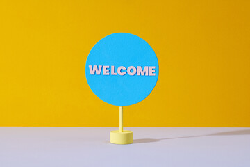 Welcome - text on a little circle on yellow bright background