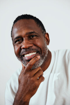 Studio portrait of happy mature man smiling 