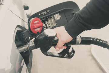 Filling the tank with fuel, a man fills the tank with diesel fuel, filling an empty tank with fuel,...