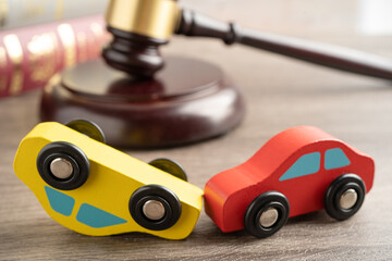 Hammer gavel judge with car vehicle accident, insurance coverage claim lawsuit court case.