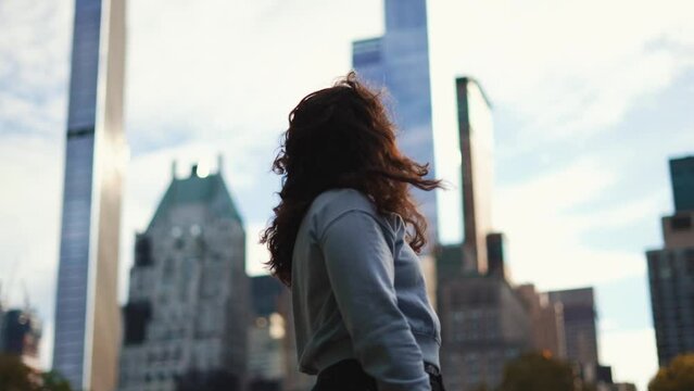 Young brunette woman looking at the Manhattan New York City skyline in slow motion