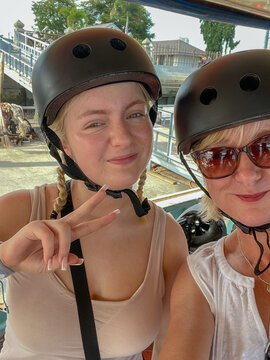 Mother and teenage daughter selfie in cycling helmets