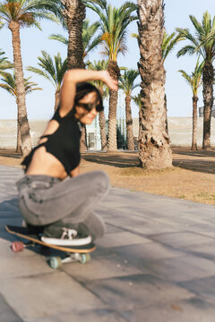 Motion blur image of a woman skateboarding