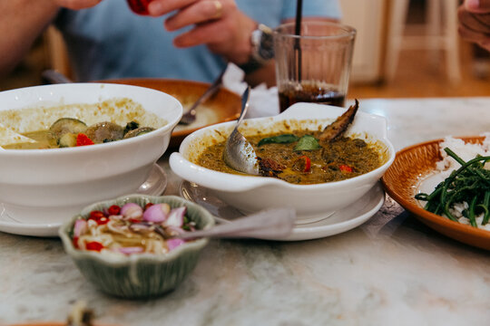 Various Thai dishes on a restaurant table in Bangkok. 