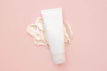 cosmetic cream tube bottle, big smear of moisturizer on pink background. moisturizing cream body...