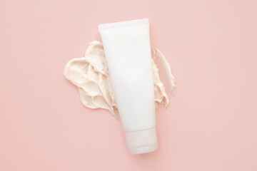 cosmetic cream tube bottle, big smear of moisturizer on pink background. moisturizing cream body skincare, facial care, sunscreen, sunblock. Cosmetic skin care product blank package, template mockup