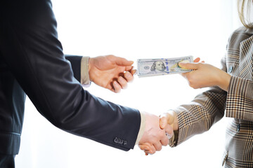 Businessmen secretly passing money - bribery and corruption concepts