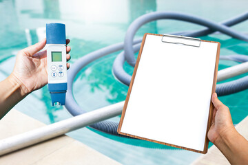 Digital water tester and blank white paper on wooden clipboard in girl hand over clear blue...