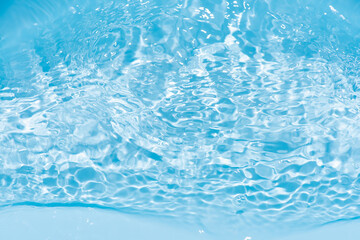 Blue water surface texture with ripples, splashes, and bubbles. Abstract summer banner background...