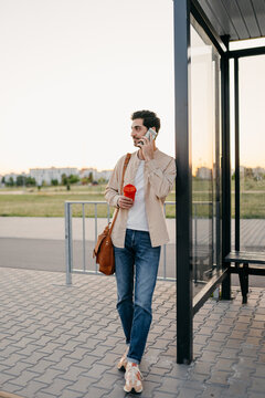 A man uses a mobile phone at a bus station