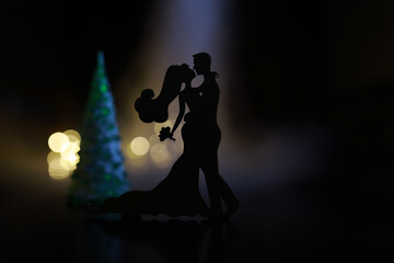 Black silhouettes of pair dancers performing. Man and woman are dancing on gray background with...