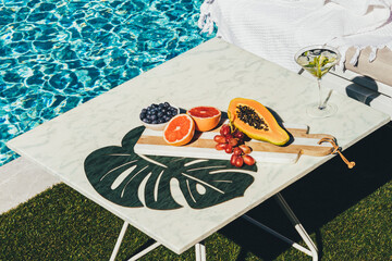 Cocktail and fruit platter poolside