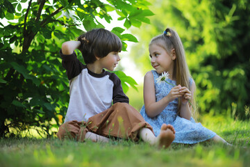 Children walk in the summer in nature. Child on a sunny spring morning in the park. Traveling with children. - 751227946