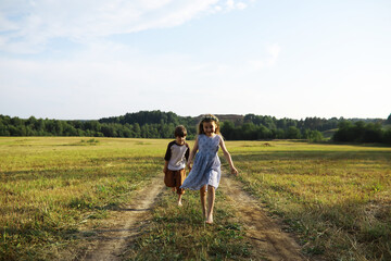 Children walk in the summer in nature. Child on a sunny spring morning in the park. Traveling with children. - 751228127