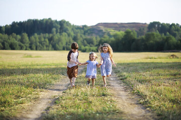 Children walk in the summer in nature. Child on a sunny spring morning in the park. Traveling with children.