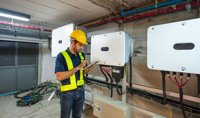 Service Engineer use tablet working inspection installation inverter solar cell. Technician...