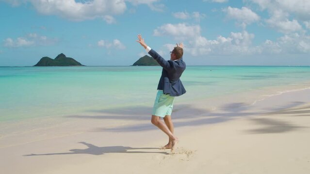 Extremely happy male tourist admiring the beauty of endless waters of tranquil ocean, raising hands with excitement, dreams come true, long awaited getaway. High quality 4k footage