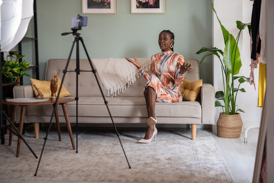 Black female influencer recording video on cellphone