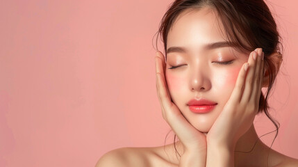 beautiful asian korean woman close her eyes and touches her face with her hands. natural makeup skin of a young beautiful model plain background with copy space. cosmetic skin care concept.