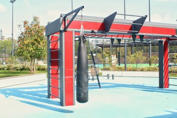 Free gym area with exercise equipment in the street. The sports ground. Outdoor fitness equipment in public park. Gym for street workout. Outdoor sports complex for training. Healthy lifestyle