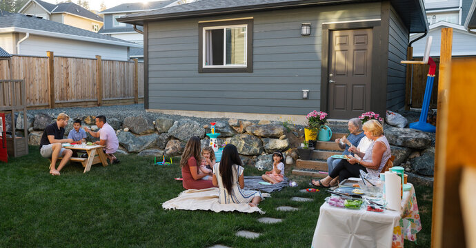 A group of family and friends enjoying a summer backyard barbequ