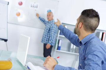 Obraz premium teacher and student pointing to a board