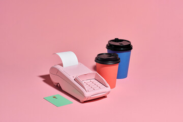 POS payment terminal and coffee on pink banner