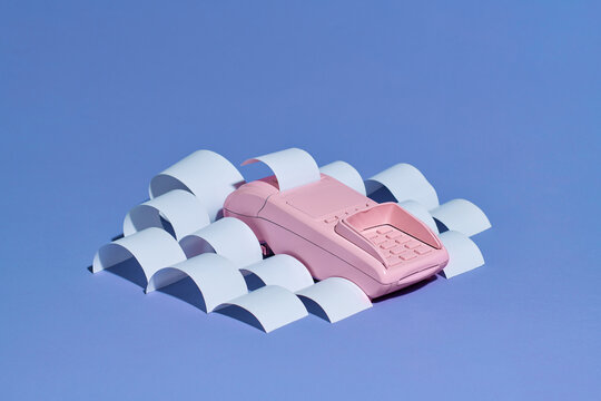 Payment terminal with cash tape on color backgroun