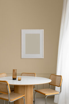 Frame with an empty space against a modern dining room