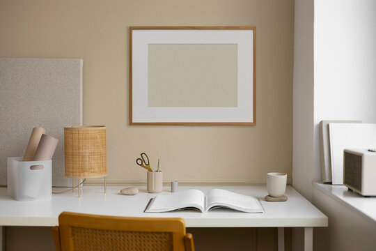 Frame with an blank space against a modern workspace