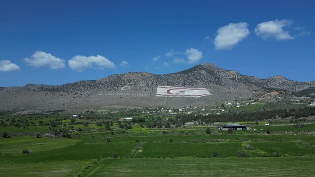 Landscape. Mountains, meadows, plains and the flag of Northern Cyprus. 