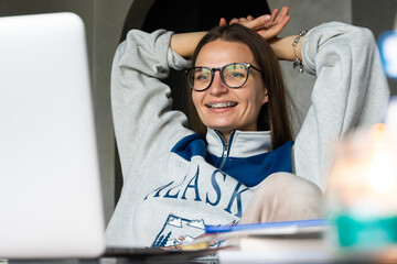Young happy woman working online remotely at home 