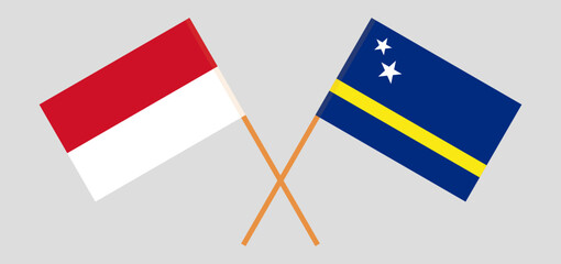 Crossed flags of Indonesia and Country of Curacao. Official colors. Correct proportion