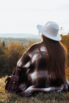 Unrecognizable woman enjoying autumn nature. 