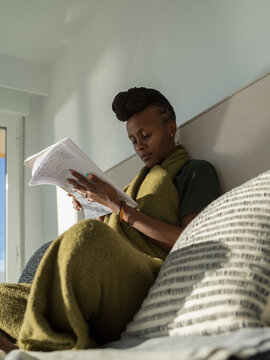 Focused black woman learning foreign language