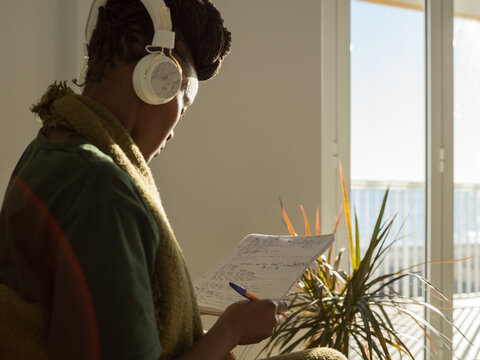 Black female listening to Spanish language audio course