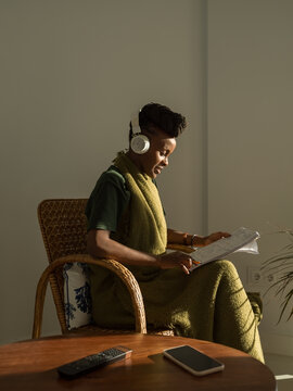 Young female in headphones learning foreign language