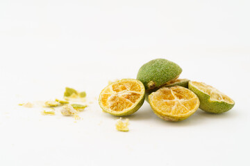 Freeze-dried small limes on a solid color background