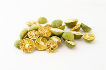 Freeze-dried small limes on a solid color background