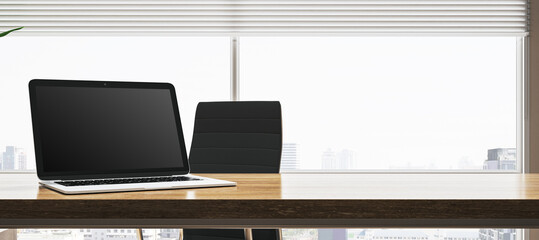 Fototapeta premium Creative wide designer desktop with empty mock up laptop, supplies. Window with city view and blinds. 3D Rendering.