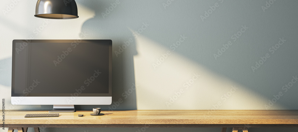 Poster Modern home office interior with empty computer monitor on designer desktop. Decorative concrete wall background with shadows. 3D Rendering.