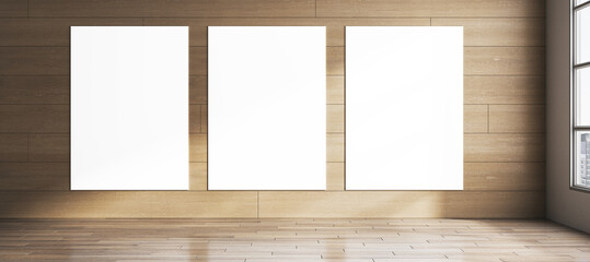 Fototapeta premium Modern wide hardwood room with blank white mock up banners on wall, window and sunlight. 3D Rendering.