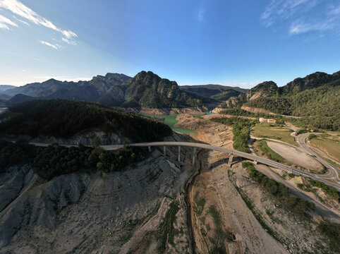 Parched drought reservoir bridge in water shortage, aerial