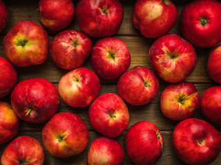 Freshly harvested red apples the wooden table. Selective focus. Shallow depth of field.