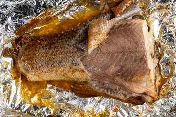 red trout fried in foil with spices, close-up