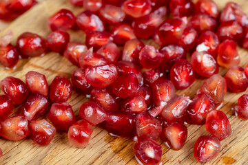 juicy pomegranate on a wooden board - 751250187