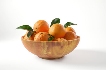 Wooden bowl with fresh oranges or tangerines with green leaf isolated on white background, front view
