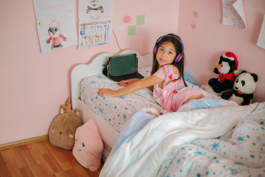 The girl is distracted from using her electronic tablet