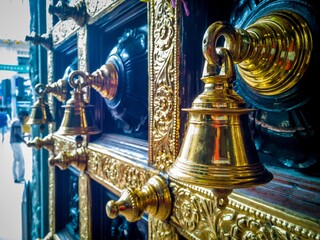 The bell hung gracefully on the wall, its polished surface gleaming in the soft light. With a...
