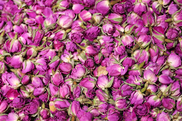 Dry roses for herbal tea, purple flowers for background